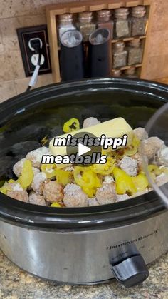 a crock pot filled with meatballs and cheese