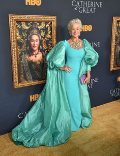 an older woman in a blue gown standing on the red carpet at hbo's game of throne