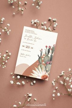 a wedding card with cactus and flowers on it next to some baby's breath