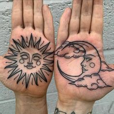 two hands with sun and moon tattoos on them