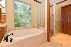 a bathroom with a large jacuzzi tub next to a walk in shower