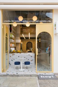 the inside of a store with two chairs in front of it and an open door