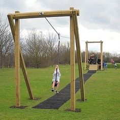 a person on a rope swing in a park