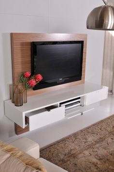 a flat screen tv sitting on top of a white entertainment center