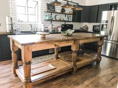 a large kitchen island in the middle of a wooden floor