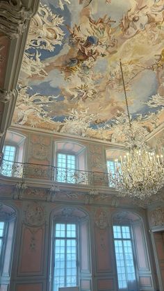 an ornate ceiling with chandeliers and paintings on the walls in a palace like setting