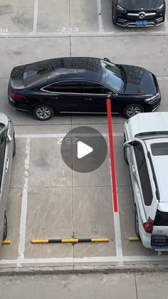 an overhead view of cars parked in a parking lot with red lines on the ground