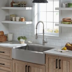 the kitchen sink is clean and ready for us to use it's stainless steel faucet