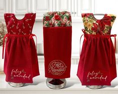 three wine bottles wrapped in red and gold fabric with the words, merry christmas written on them