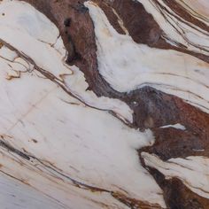 an image of marble that looks like it has brown and white streaks on the surface