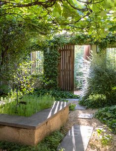 a stone bench sitting in the middle of a garden