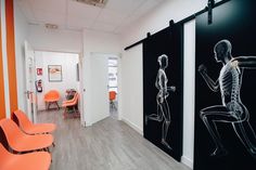 an office with two black and white skeleton images on the wall