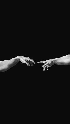 two hands reaching out towards each other in black and white, against a dark background