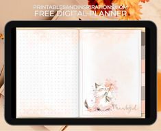 an open notebook with flowers on it and the words free digital planner written in front