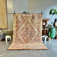 an old rug is on display in a room