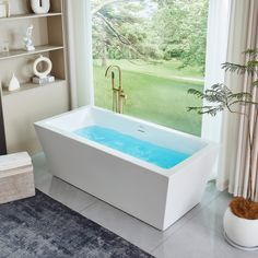 a bathtub with blue water in front of a window