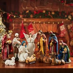 a group of figurines sitting on top of a table next to a christmas tree