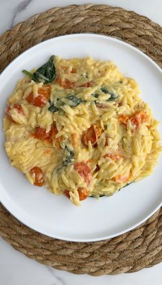 pasta with tomatoes and spinach on a white plate