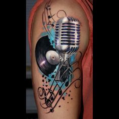 a man with a tattoo on his arm has a microphone and music notes around it