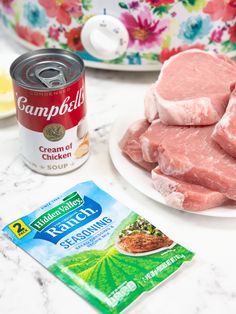 raw meat on a white plate next to a can of campbells creamed ground beef