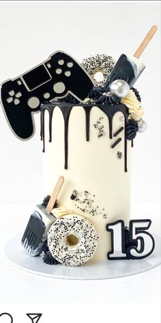 a birthday cake decorated with black and white decorations