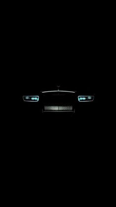 a car is shown in the dark with its headlights turned on and it's hood up