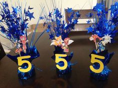 three vases filled with blue and gold decorations