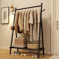 an iron rack with clothes and shoes on it