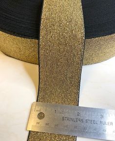 a black and gold hat with a measuring tape