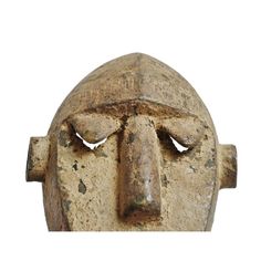 an old stone mask with two eyes on it's face and one eye closed