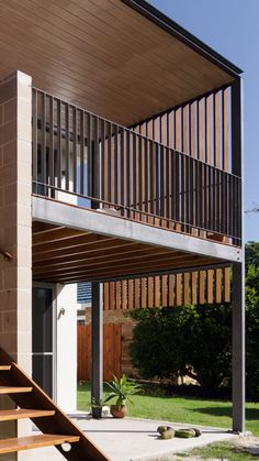 the stairs lead up to the upper level of this modern house, which is built in brick and steel