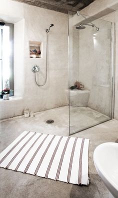 a bathroom with a sink, shower and bathtub next to a window in it