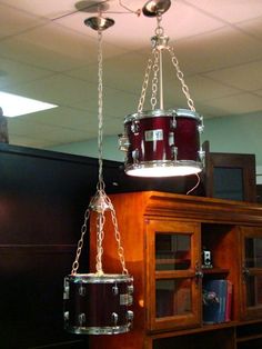 a drum is suspended from the ceiling by chains