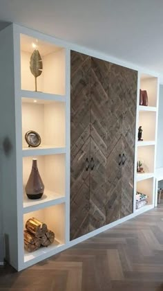 a room that has some shelves with vases on them and other items in it