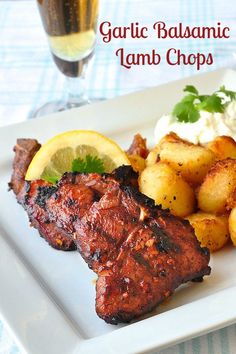 grilled lamb chops with garlic and potatoes on a white plate