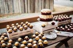 an assortment of cupcakes and dessert items on a table