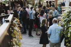 a crowd of people standing around each other