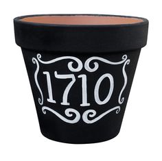 a black pot with white lettering on the front and bottom that says,'1917 '