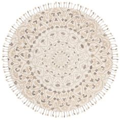 a round rug with an intricate design on the center and fringes in the middle