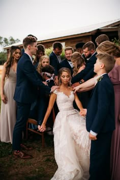 the bride and groom are surrounded by their wedding party