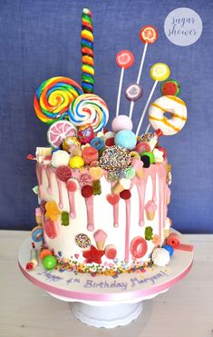 a birthday cake decorated with candies and lollipops