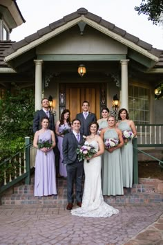 a group of people standing in front of a house