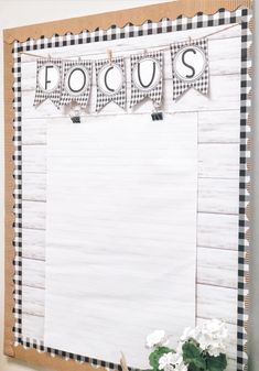 a white board with black and white checkered paper hanging from it's sides