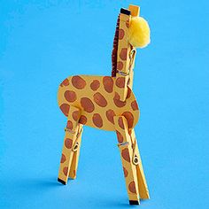 a toy giraffe made out of wood on a blue background