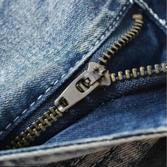 the zipper is visible on an old pair of jeans