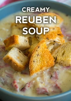 creamy reuben soup in a blue bowl with croutons