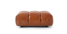 a brown leather ottoman sitting on top of a white floor