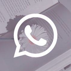 an open book with a white flower in the middle and a phone icon above it