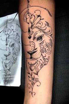 a lion tattoo on the arm next to a piece of paper