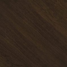 a close up view of the wood grains on this flooring material, which is dark brown in color